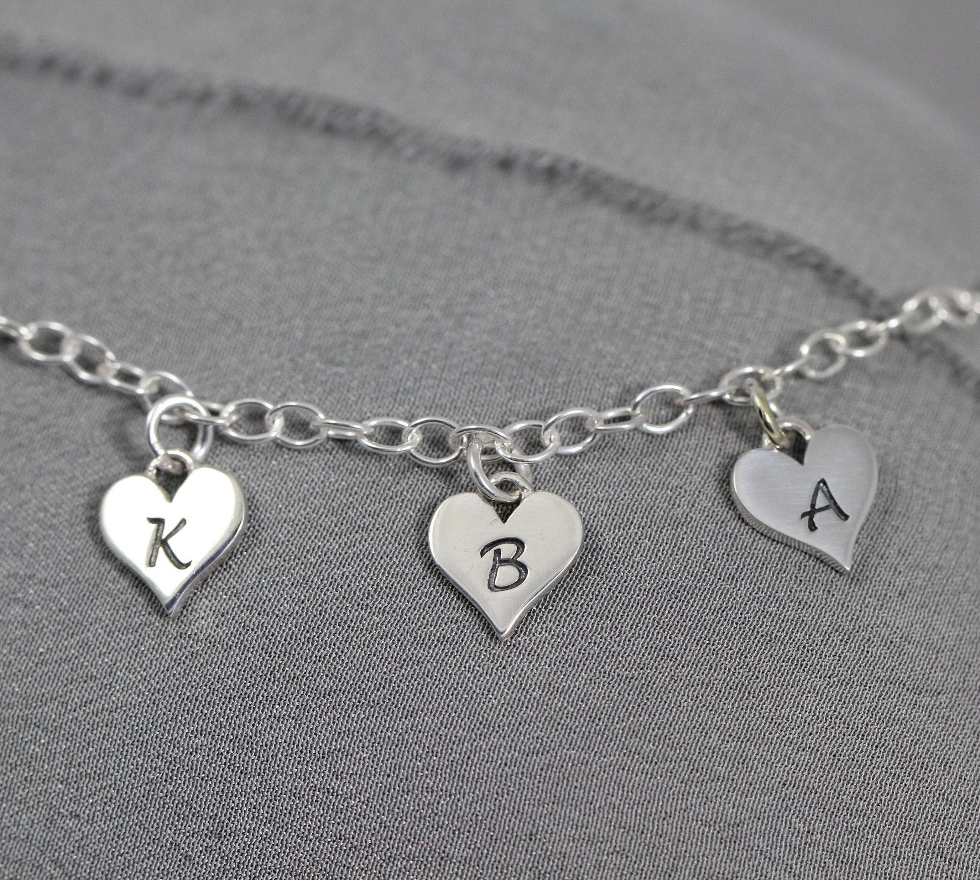Letter bracelet with heart charms